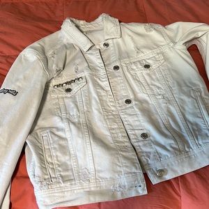 Women’s light wash jean jacket with a various patches